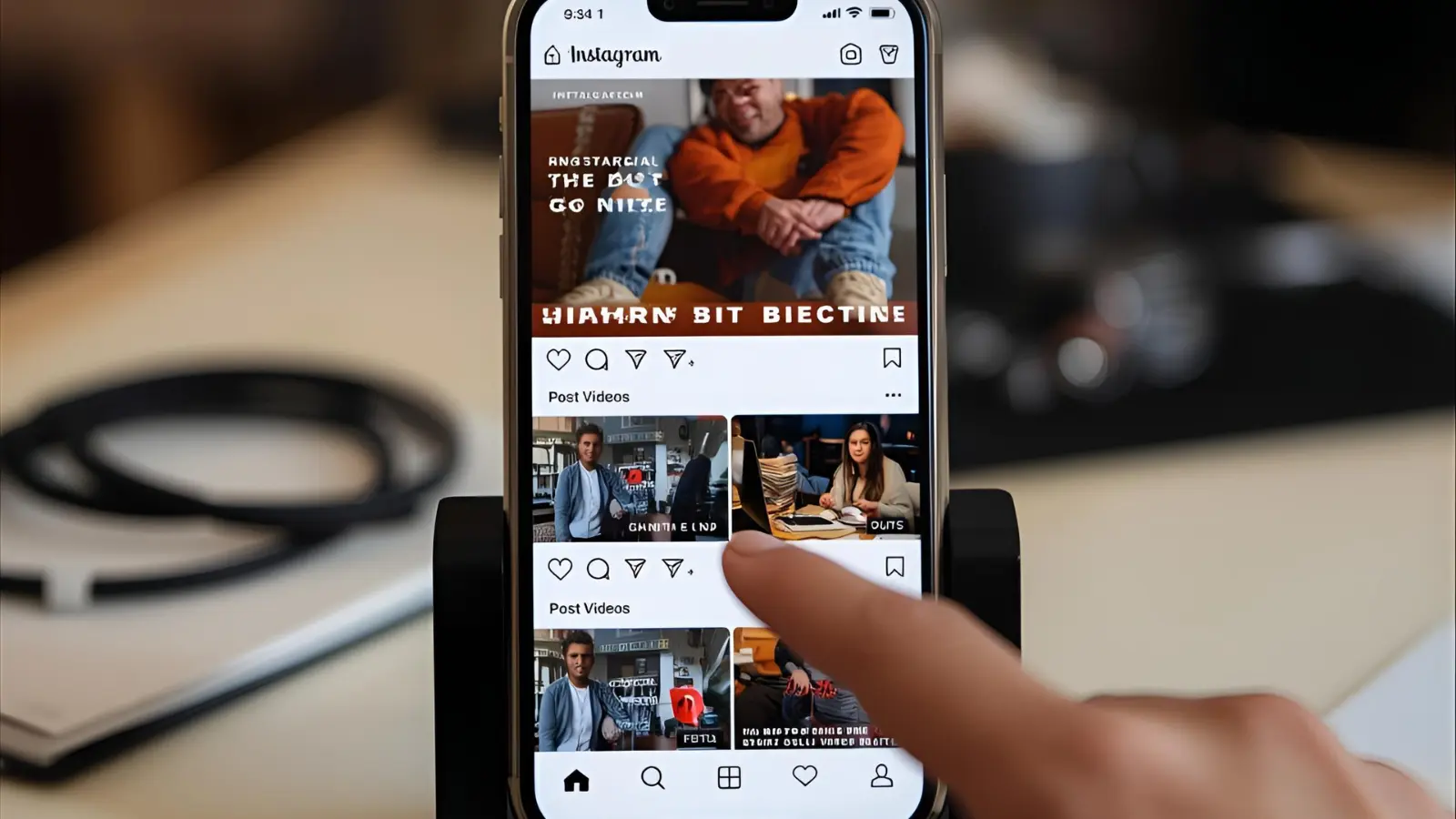 Phone screen showing Instagram Reels with short captions under trending vertical videos on a creator’s desk.